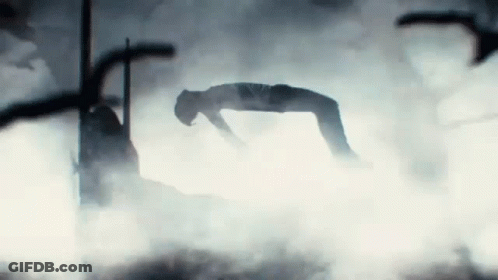 A Person Is Laying On Their Back In A Foggy Room GIF