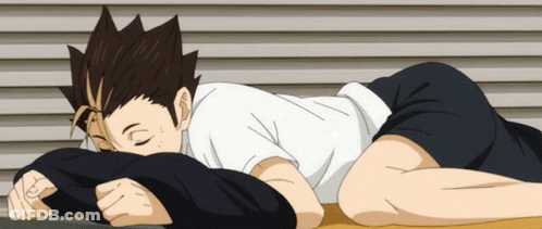 A Person Is Laying On Their Stomach With Their Head On A Pillow GIF