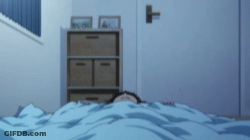 A Person Is Laying Under A Blue Blanket With Their Eyes Closed GIF