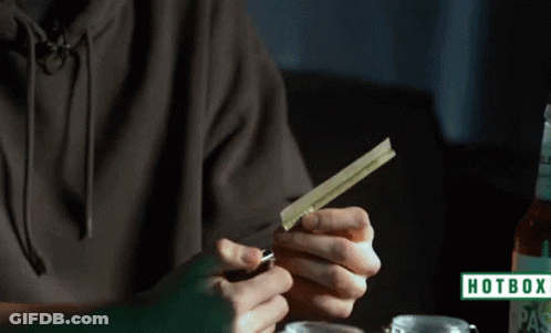 A Person Is Lighting A Cigarette With A Hotbox Logo In The Corner GIF