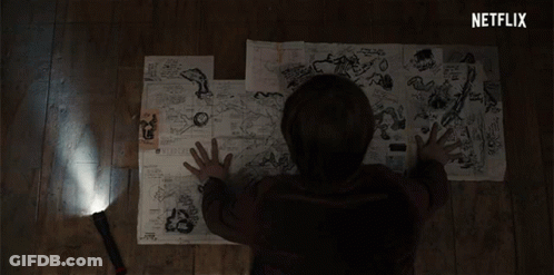 A Person Is Looking At A Map With A Netflix Logo Behind Them GIF