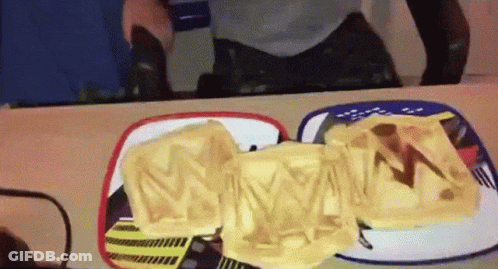 A Person Is Looking At Their Reflection In A Mirror While Eating A Sandwich With The Letter M On It GIF