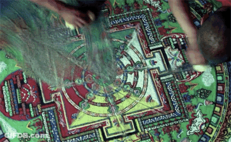 A Person Is Making A Colorful Mandala With The Letter L In The Middle GIF