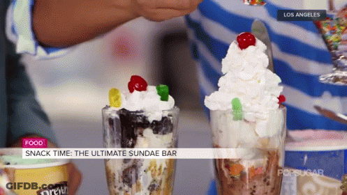 A Person Is Making A Sundae With Gummy Bears On Top GIF