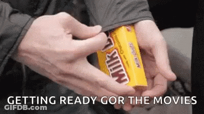 A Person Is Opening A Box Of Milky Way Candy GIF