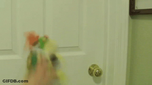 A Person Is Opening A Door With A Bottle Of Toothpaste On It . GIF