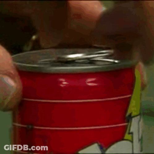 A Person Is Opening A Red Can Of Soda With A Lightning Bolt On It GIF
