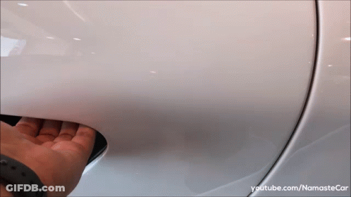 A Person Is Opening The Door Of A White Car With Youtube.com/namastecar Written On The Bottom GIF