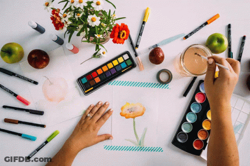 A Person Is Painting A Flower On A Piece Of Paper With A Palette Of Watercolors GIF