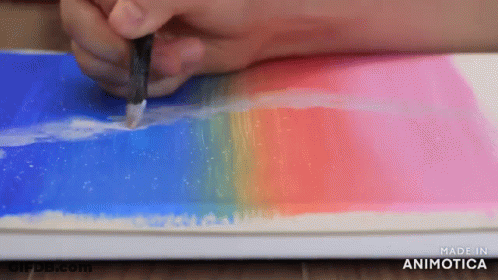 A Person Is Painting A Picture With A Brush On A Piece Of Paper . GIF