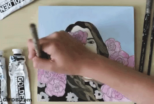 A Person Is Painting A Picture With A Tube Of Golden Acrylic Paint GIF
