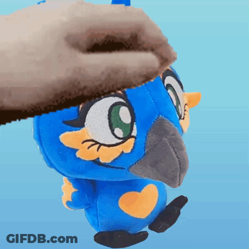 A Person Is Petting A Blue Stuffed Animal With A Yellow Heart On Its Chest GIF