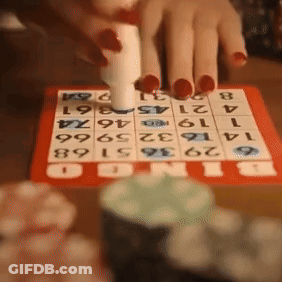 A Person Is Playing A Game Of Bingo With Numbers On A Board GIF