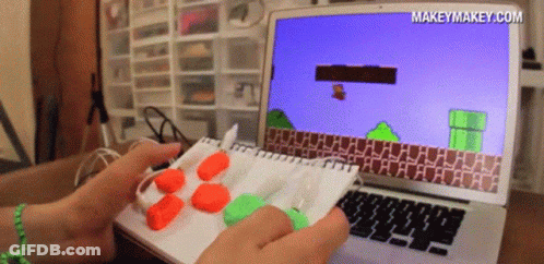 A Person Is Playing A Video Game On A Laptop With The Website Makeymakey.com Displayed On The Screen GIF