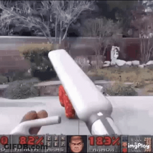 A Person Is Playing A Video Game With A Remote Control In Their Hands . GIF