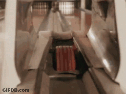 A Person Is Playing Bowling In A Bowling Alley With A Red Ball In The Middle . GIF