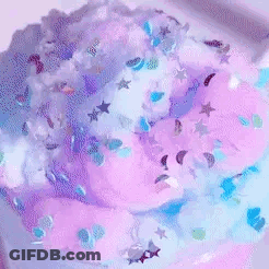 A Person Is Playing With A Purple And Blue Slime . GIF