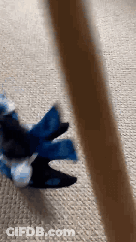 A Person Is Playing With A Toy On The Floor GIF