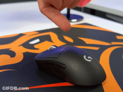 A Person Is Pointing At A Black Logitech Mouse GIF
