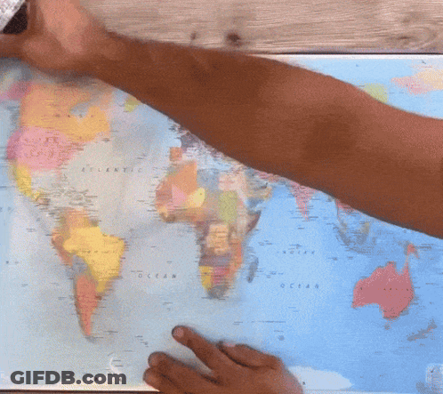 A Person Is Pointing At A Map Of The World Which Shows The Ocean GIF