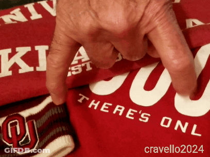 A Person Is Pointing At A Red Shirt That Says There 'S One GIF