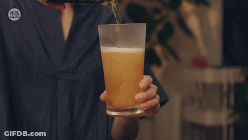 A Person Is Pouring Beer Into A Glass With A Sticker That Says ' Taiwanese ' On It GIF