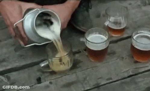 A Person Is Pouring Beer Into Four Mugs On A Wooden Table GIF