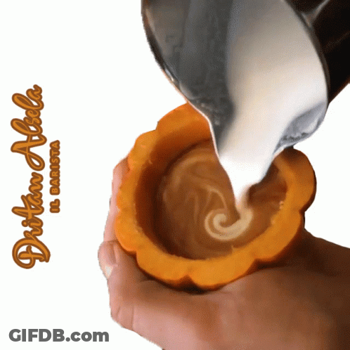 A Person Is Pouring Milk Into A Pumpkin Shaped Cup With The Name Dritan Alicha Written On The Bottom GIF