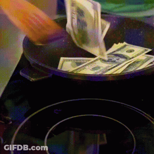 A Person Is Pouring Money Into A Frying Pan That Has Twenty Dollar Bills On It GIF