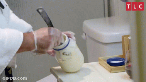 A Person Is Pouring Something Into A Jar With Tlc Written On The Top GIF