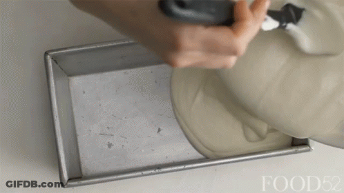 A Person Is Pouring Something Into A Pan With The Words Food52 Visible GIF