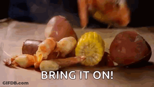 A Person Is Preparing A Crawfish Boil With Shrimp , Corn , Potatoes , Onions And Sausage . GIF