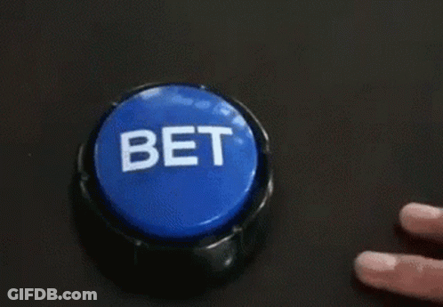 A Person Is Pressing A Blue Button That Says Bet On It . GIF