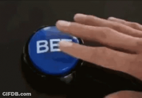 A Person Is Pressing A Blue Button With Their Finger That Says Be . GIF