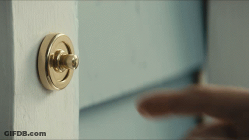 A Person Is Pressing A Doorbell On A Door GIF