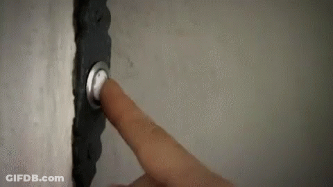 A Person Is Pressing A Doorbell With Their Finger On A Wall . GIF