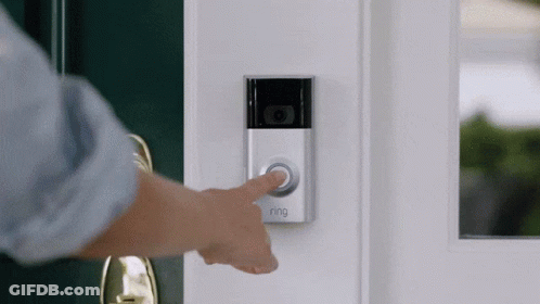 A Person Is Pressing A Ring Doorbell Button On A Door GIF