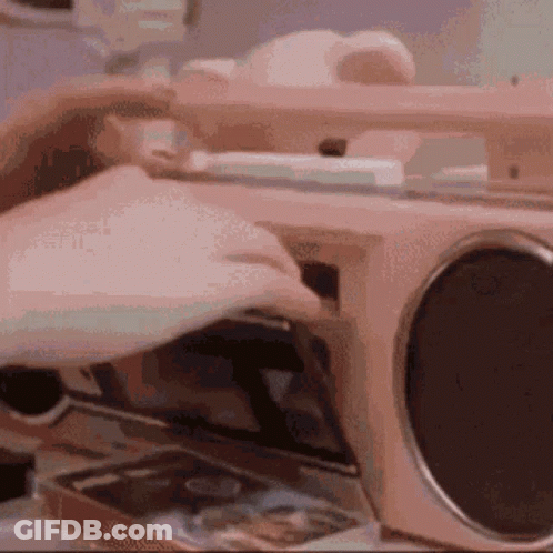 A Person Is Putting A Cd Into A Radio . GIF