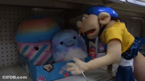 A Person Is Putting Stuffed Animals In A Box That Says ' Squishee ' On It GIF