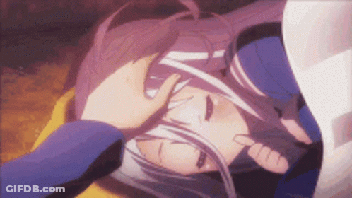 A Person Is Putting Their Hand On A Girl 'S Head . GIF
