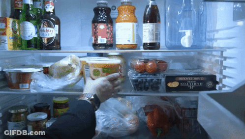 A Person Is Reaching Into A Fridge With A Hamilton Cheese Box On The Bottom Shelf GIF