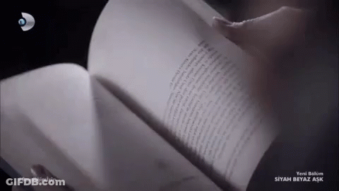 A Person Is Reading A Book With The Word Siyah Beyaz Aşk On The Bottom Right GIF