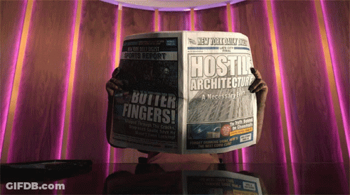 A Person Is Reading A Newspaper With The Title Hostile Architecture GIF