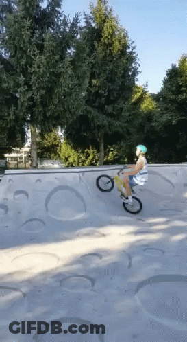 A Person Is Riding A Bike On A Ramp In A Skate Park GIF