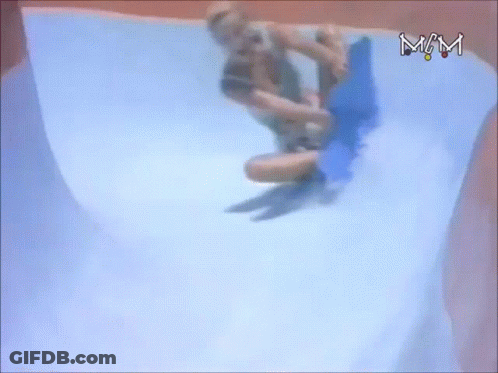 A Person Is Riding A Blue Board Down A Water Slide With The Letters Mm Visible GIF