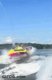 A Person Is Riding A Colorful Raft In The Water GIF