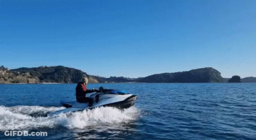 A Person Is Riding A Jet Ski In The Water GIF