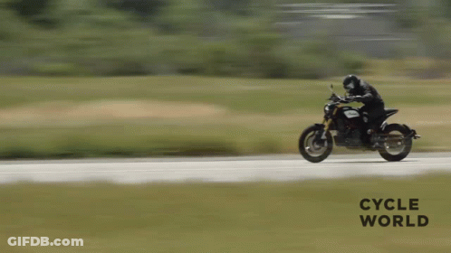 A Person Is Riding A Motorcycle On A Road With The Words Cycle World Written On The Bottom GIF