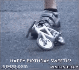 A Person Is Riding A Small Bicycle On A Street . GIF