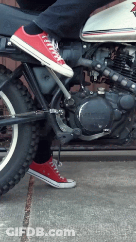 A Person Is Riding A Yamaha Motorcycle With Converse Shoes On GIF